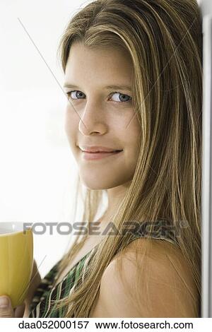 Stock Photo - Young woman with cup of coffee, portrait. Fotosearch