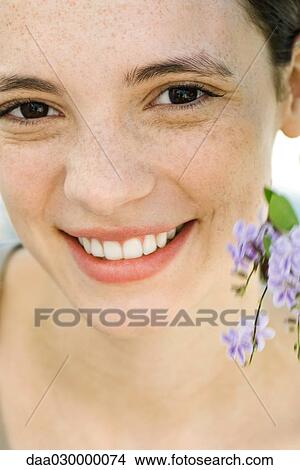 Young woman with flowers, close-up View Large Photo Image Picture - Young woman with flowers, close-up. Fotosearch