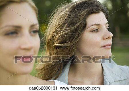 Young woman with friend outdoors View Large Photo Image Stock Image - Young woman with friend outdoors. Fotosearch