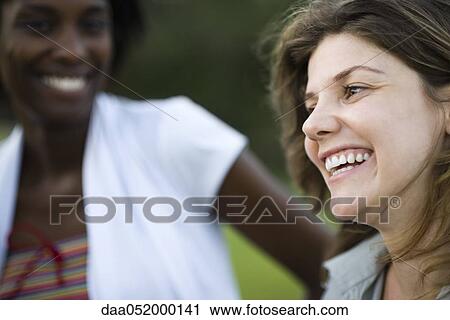 Stock Image - Young woman with friend, portrait. Fotosearch