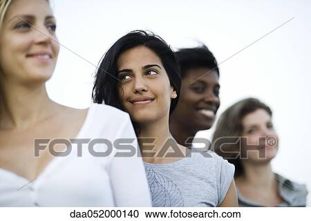 Stock Image - Young woman with friends, portrait. Fotosearch