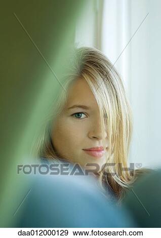 Young woman with hair covering one eye View Large Photo Image Stock Photo - Young woman with hair covering one eye. Fotosearch