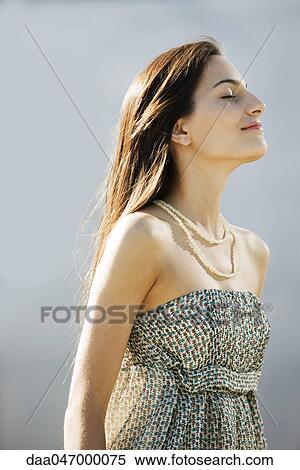 Young woman with head back, eyes closed, portrait View Large Photo Image Stock Photography - Young woman with head back, eyes closed, portrait. Fotosearch