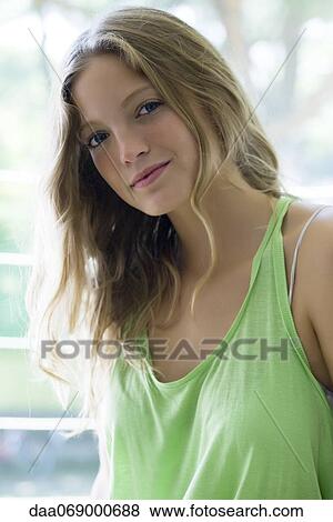 Young woman with head tilted, portrait View Large Photo Image Stock Photo - Young woman with head tilted, portrait. Fotosearch