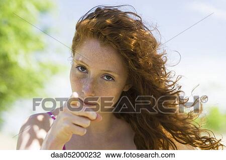 Young woman with look of reproach pointing finger at camera View Large Photo Image Stock Image - Young woman with look of reproach pointing finger at camera. Fotosearch