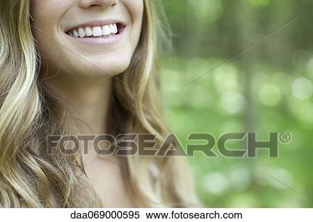 Young woman with toothy smile, cropped View Large Photo Image Stock Photography - Young woman with toothy smile, cropped. Fotosearch