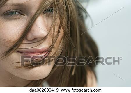 Stock Photo - Young woman with tousled hair, portrait. Fotosearch