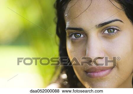 Stock Photo - Young woman with wet face and hair, portrait. Fotosearch