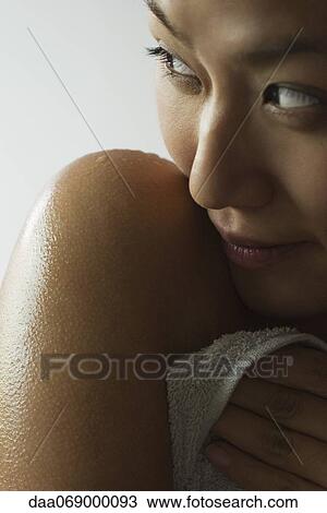 Stock Image - Young woman with wet shoulder, cropped. Fotosearch