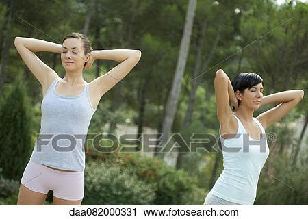 Stock Image - Young women exercising outdoors. Fotosearch