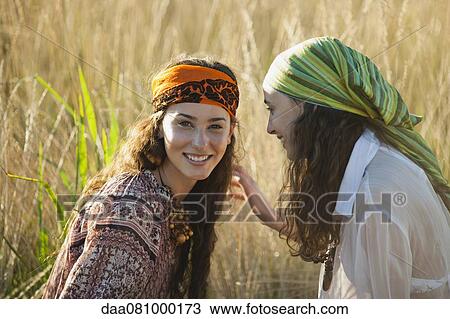 Stock Image - Young women in grass. Fotosearch