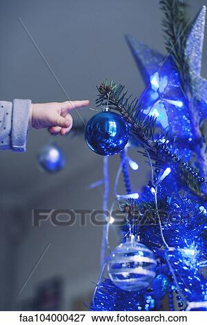 Baby reaching for Christmas tree ornament View Large Photo Image Stock Photo - Baby reaching for Christmas tree ornament. Fotosearch