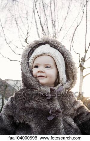 Baby wearing fur coat outdoors, portrait View Large Photo Image Stock Photo - Baby wearing fur coat outdoors, portrait. Fotosearch