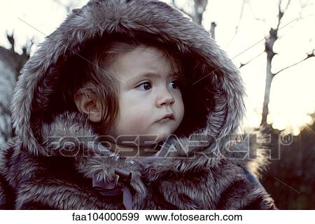 Baby wearing fur coat outdoors, portrait View Large Photo Image Stock Photo - Baby wearing fur coat outdoors, portrait. Fotosearch