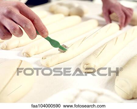 Baker scoring bread dough, cropped View Large Photo Image Stock Image - Baker scoring bread dough, cropped. Fotosearch
