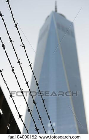 Stock Image - Barbed wire in front of One World Trade Center, Manhattan, New York City, New York, USA. Fotosearch