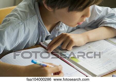 Stock Photograph - Boy studying. Fotosearch
