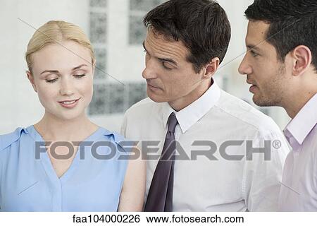 Stock Photograph - Business colleagues talking together. Fotosearch
