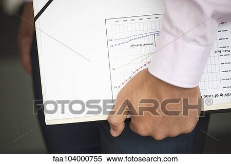 Businessman carrying documents under arm View Large Photo Image Stock Photography - Businessman carrying documents under arm. Fotosearch