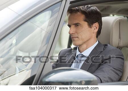 Businessman driving car View Large Photo Image Stock Photo - Businessman driving car. Fotosearch