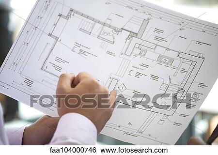 Businessman holding blueprint, close-up View Large Photo Image Stock Photograph - Businessman holding blueprint, close-up. Fotosearch