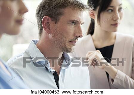 Businessman listening attentively in meeting View Large Photo Image Stock Image - Businessman listening attentively in meeting. Fotosearch
