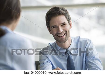 Stock Image - Businessman meeting with client. Fotosearch