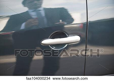 Businessman reflected on car door View Large Photo Image Picture - Businessman reflected on car door. Fotosearch