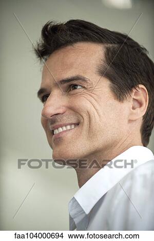 Businessman smiling cheerfully, portrait View Large Photo Image Picture - Businessman smiling cheerfully, portrait. Fotosearch