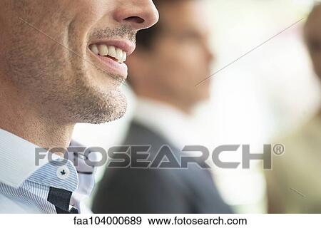Stock Photo - Businessman smiling, close-up. Fotosearch