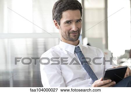 Businessman using digital tablet View Large Photo Image Stock Photo - Businessman using digital tablet. Fotosearch