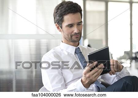 Businessman using digital tablet View Large Photo Image Stock Photograph - Businessman using digital tablet. Fotosearch