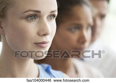 Stock Photograph - Businesswoman with colleagues, portrait. Fotosearch