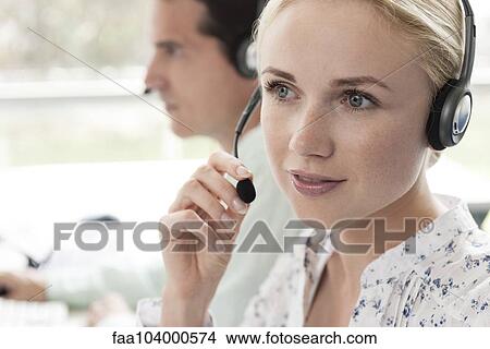 Picture - Call center operators provide daily customer service. Fotosearch