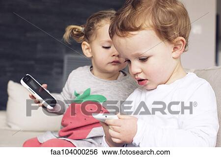Children playing with smartphones View Large Photo Image Stock Photograph - Children playing with smartphones. Fotosearch