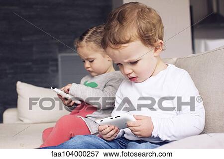 Stock Photo - Children using smartphones. Fotosearch