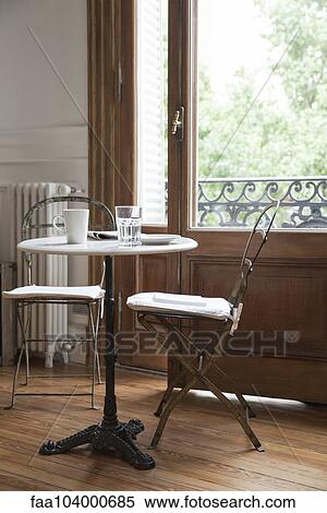 Stock Photography - Coffee cup, glass and newspaper on table. Fotosearch