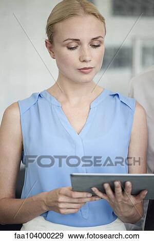 Colleagues looking at digital tablet View Large Photo Image Stock Photo - Colleagues looking at digital tablet. Fotosearch
