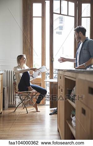 Couple chatting in kitchen View Large Photo Image Stock Image - Couple chatting in kitchen. Fotosearch