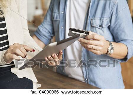 Couple using digital tablet to shop online View Large Photo Image Stock Photograph - Couple using digital tablet to shop online. Fotosearch