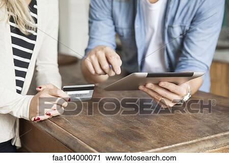 Stock Image - Demonstrating online banking. Fotosearch