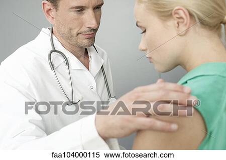 Stock Photography - Doctor comforting upset patient. Fotosearch