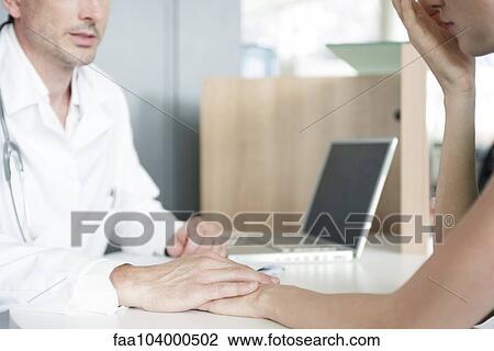 Doctor consoling patient after delivering bad news, cropped View Large Photo Image Stock Image - Doctor consoling patient after delivering bad news, cropped. Fotosearch
