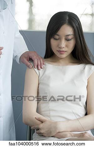 Doctor consoling patient View Large Photo Image Stock Photograph - Doctor consoling patient. Fotosearch