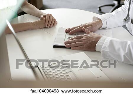 Stock Photo - Doctor presenting test results to patient. Fotosearch