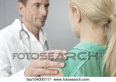 Doctor reassuring patient View Large Photo Image Stock Photo - Doctor reassuring patient. Fotosearch