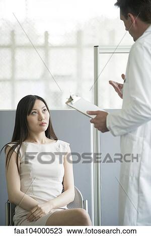 Doctor speaking with patient in waiting room View Large Photo Image Stock Image - Doctor speaking with patient in waiting room. Fotosearch