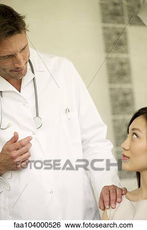 Stock Photograph - Doctor talking with patient. Fotosearch