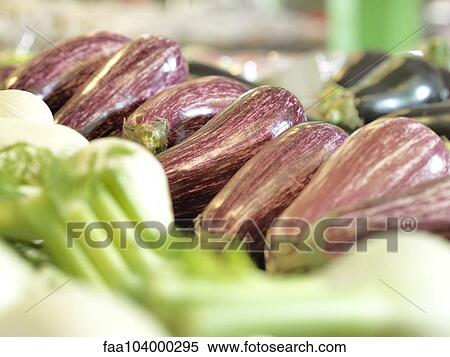 Stock Photography - Eggplants with other vegetables on display at supermarket. Fotosearch