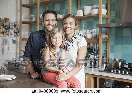 Stock Photography - Family at home together in kitchen, portrait. Fotosearch